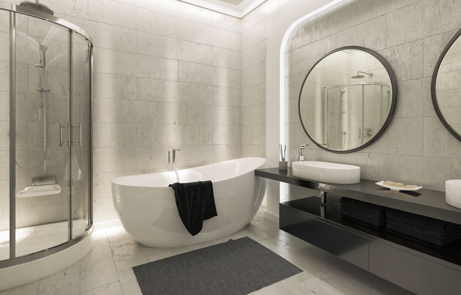 Baño de diseño tras reforma integral con bañera exenta y mobiliario a medida por Reformas Noriega